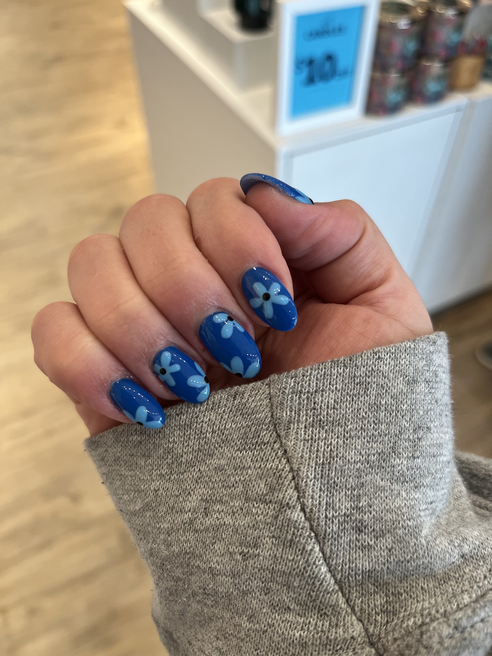 Blue nails with hand-painted white daisies