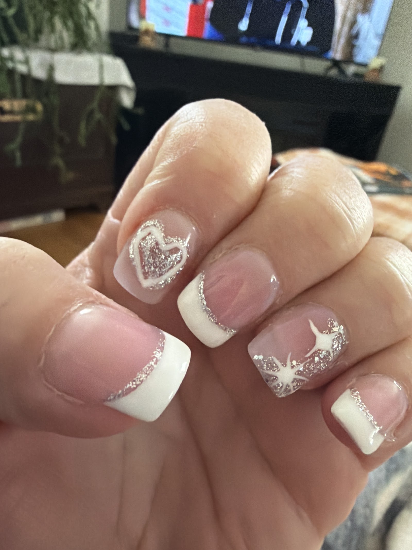 White French tips with silver glitter and small star artwork